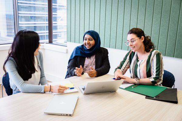 NSW Treasury staff having a meeting around a table