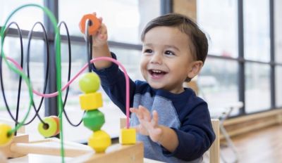 Child playing with toys in a preschool room