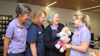 Midwives holding a baby