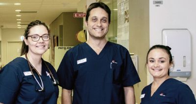 Three Registered Nurses working in a hospital and smiling