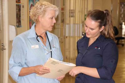 Two health professionals discussing a patient file