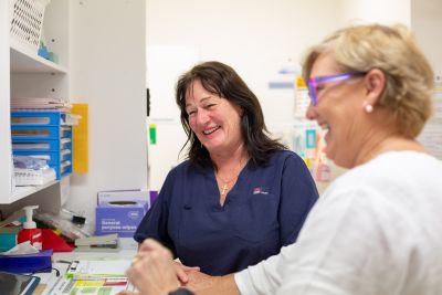 Two staff members from Gulargambone smile while undertaking some work