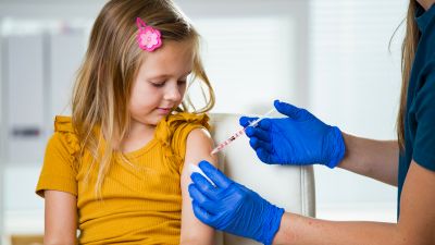 A little girl receiving a vaccine