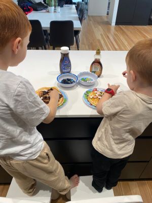 Two early stage 1 children eating in home schooling cooking class