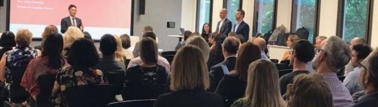 A crowd of people watching a presentation