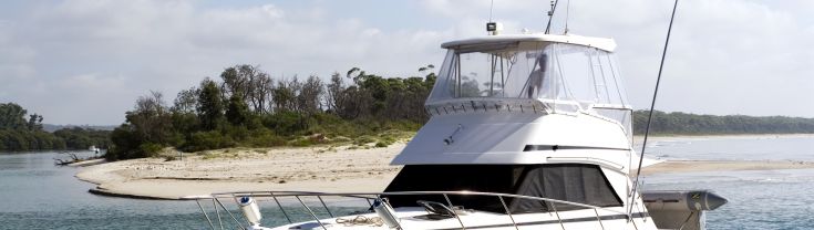 Boat parked off-shore by sandy beach