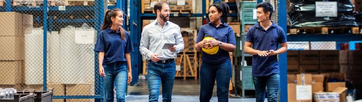 Group of workers talking to their manager in a warehouse