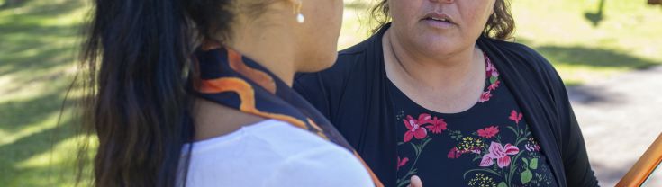 Two women are talking outdoors