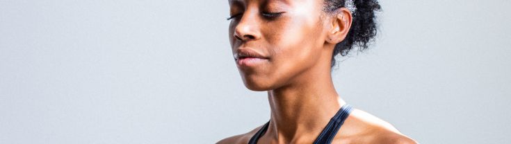 Young woman with eyes closed and hands in together in prayer