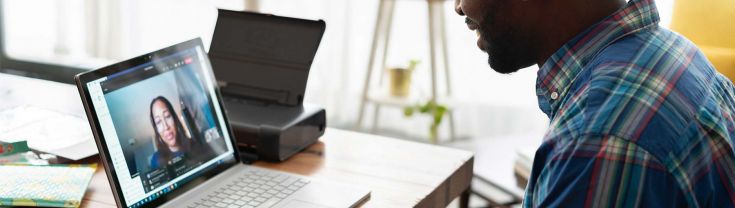 A man on a video call on a laptop