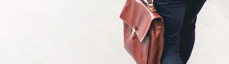 Briefcase carried by a man in a suit