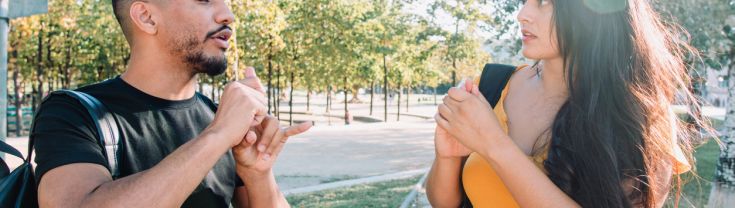 Latinix male and female college students using sign language