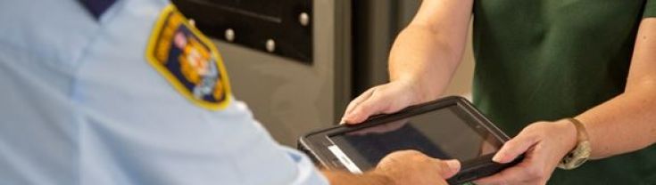 A prisoner receiving a tablet device to use