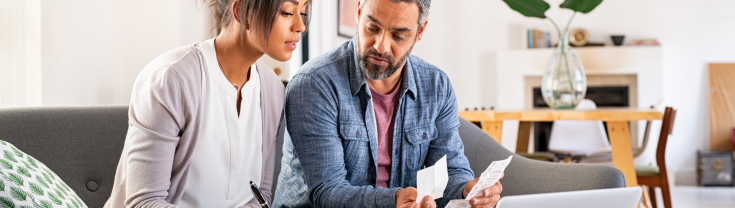 Woman and man paying fines on laptop