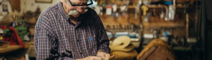 man in a workshop tinkering 