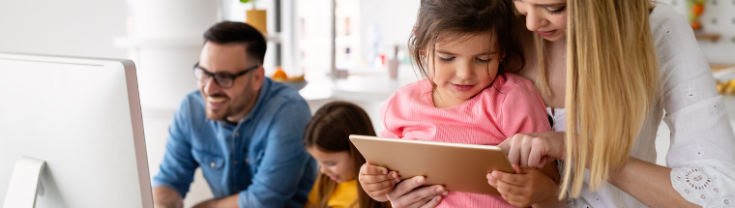 family with little kids using devices