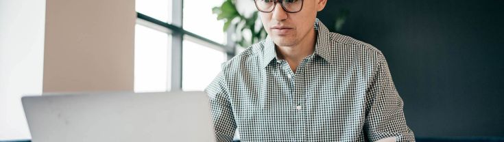 Man sitting in front of a laptop