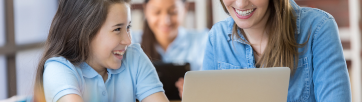 Student and teacher using computer