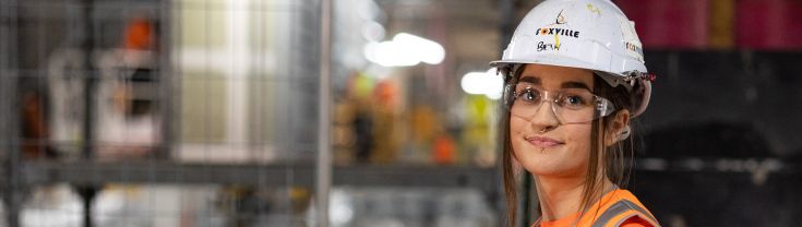 Bethany is standing on a construction site.