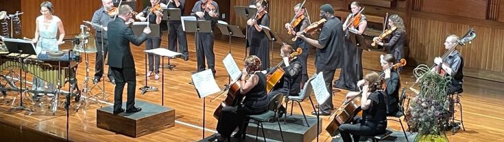 Claire Edwards conducting Steel Strings orchestra 