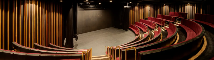 Empty theatre with seats around stage