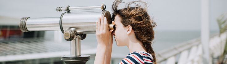 Girl using a telescope