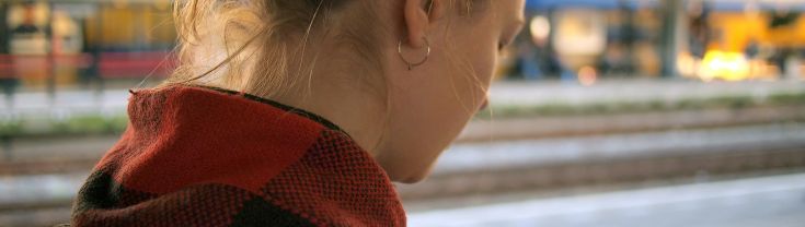 Close up of teen from behind, using their phone.