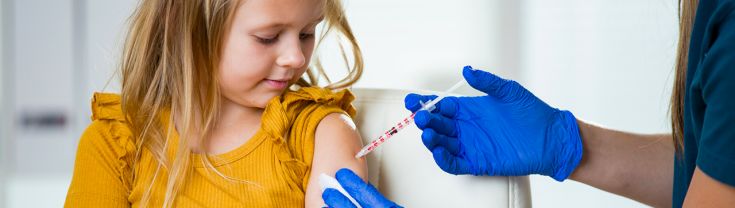 A little girl receiving a vaccine