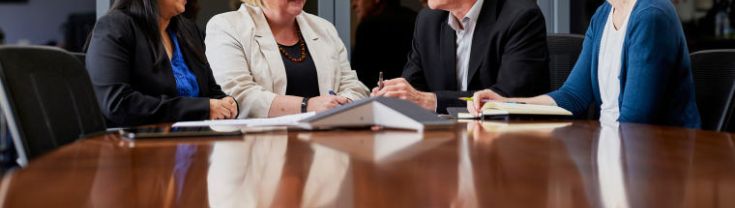 4 people in meeting room chatting