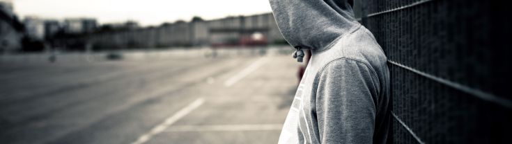 Teenage boy leaning against wall