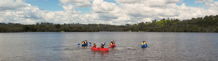 people canoeing on a lake in nsw