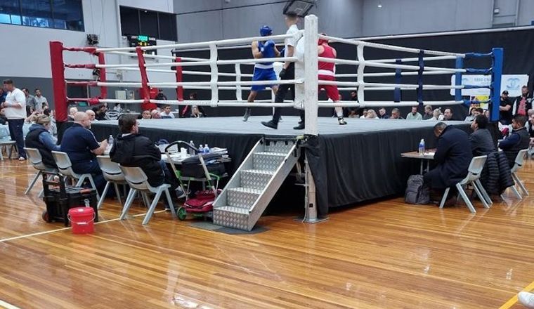 Boxing ring with two fighters and a ref