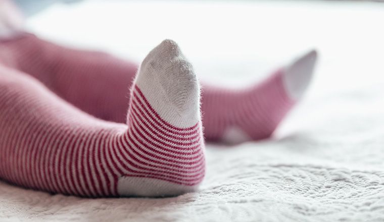 baby feet in striped socks