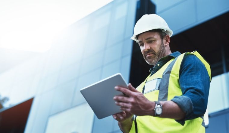 A male using a digital tablet on a construction site