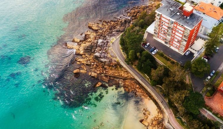 Overhead view of swimmers going for a swim at Manly beach in Sydney, Australia.