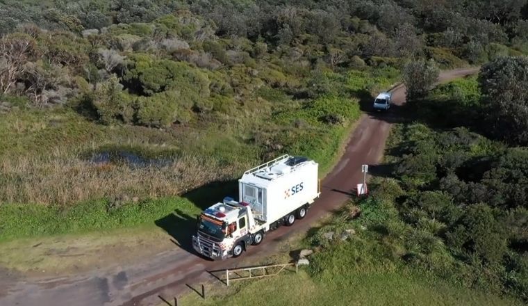 SES Unimog vehicle travelling on a dirt road.