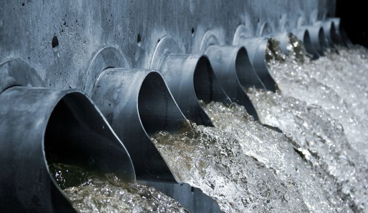 Water gushing out of steel spouts.