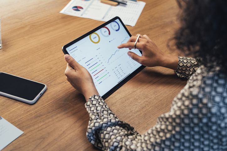 Worker on tablet displaying graphs