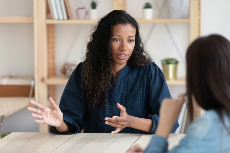 Two women have a conversation 