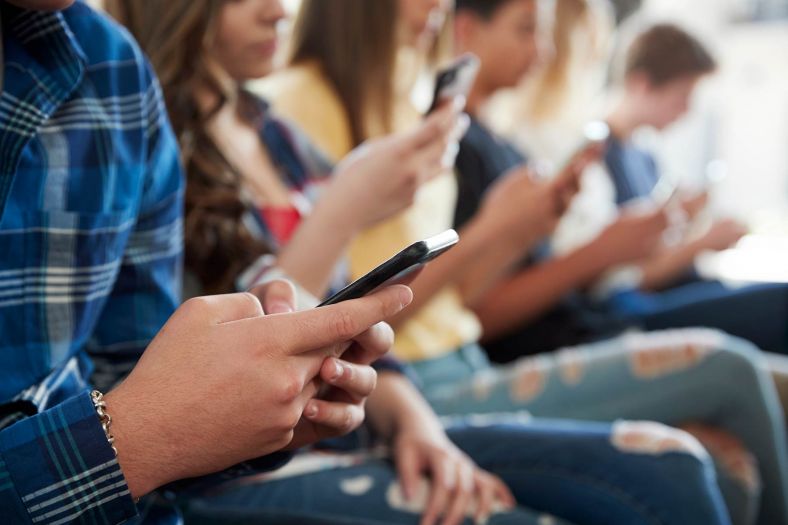 Young people looking at their mobile phones