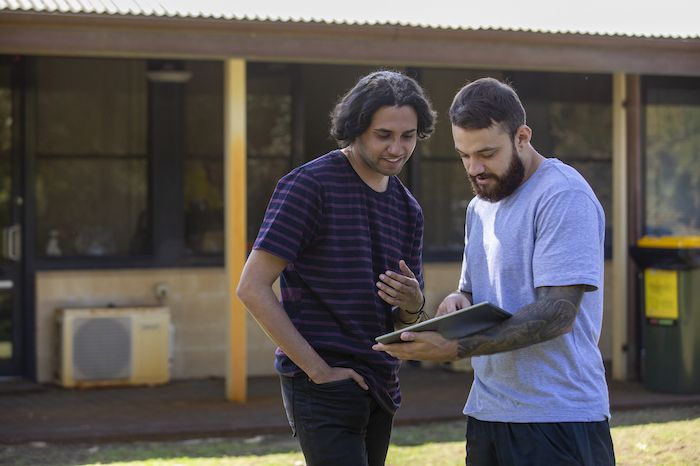 Two Aboriginal men have a discussion