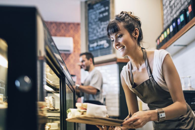 A waitress preparing food at a cafe