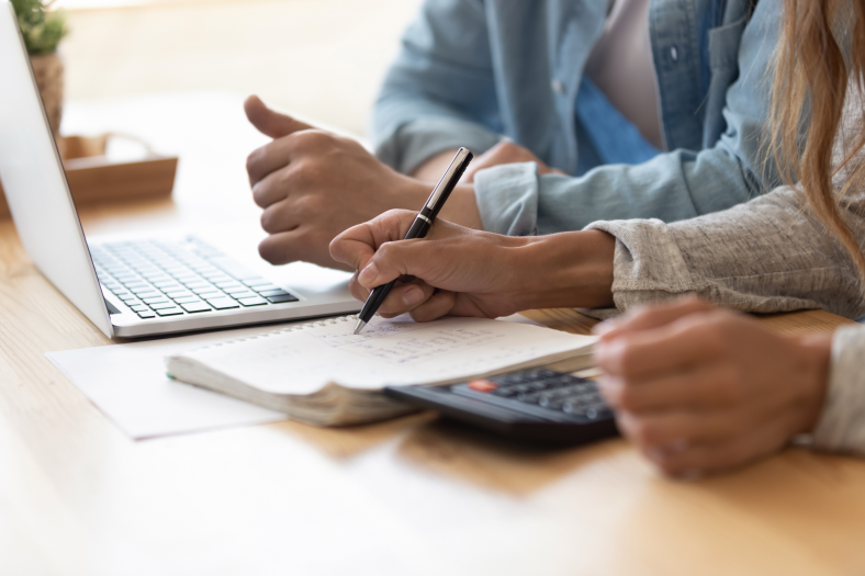 Man and woman working out finances