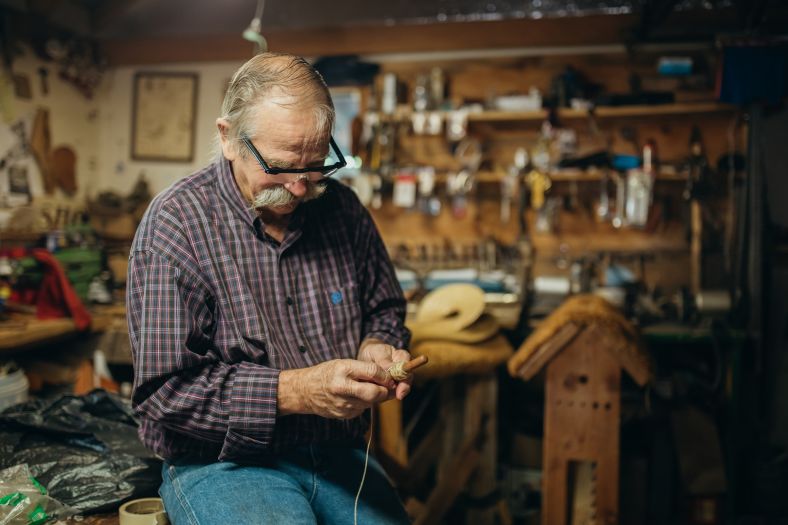 man in a workshop tinkering 