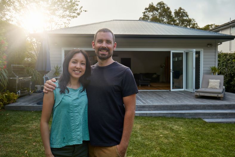 A couple standing in their backyard