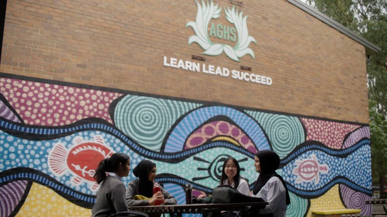 Four Students at Auburn Girls High School talking in outdoor setting.