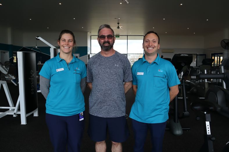 Cancer care patient Keith Cooper (middle) with WNSWLHD Exercise Physiologists Hannah McDermott (left) and Dylan West (right) in the gym during a program session