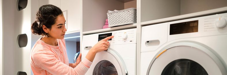 Lady looking at a washing machine