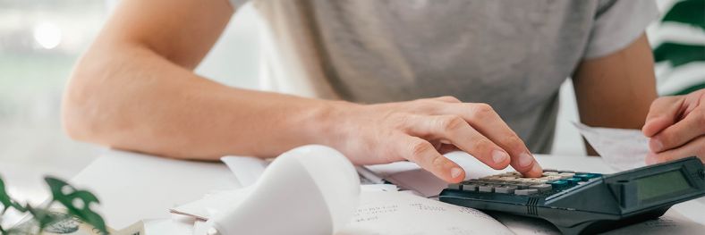 Person using a calculator on a table