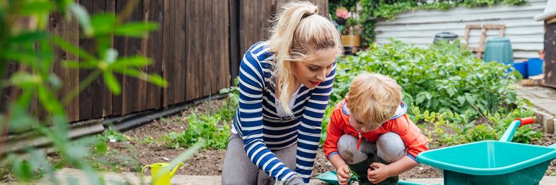 Women and young child planting vegetables 